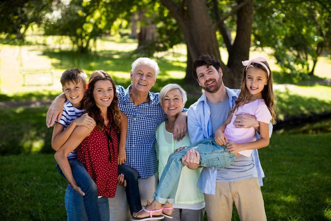 A multigenerational family smiling together outdoors